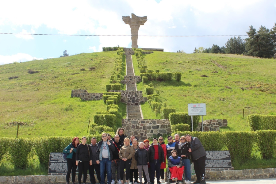 1.Grupa uczestników oraz kadry pozują do zdjęcia na tle Góry Czcibora