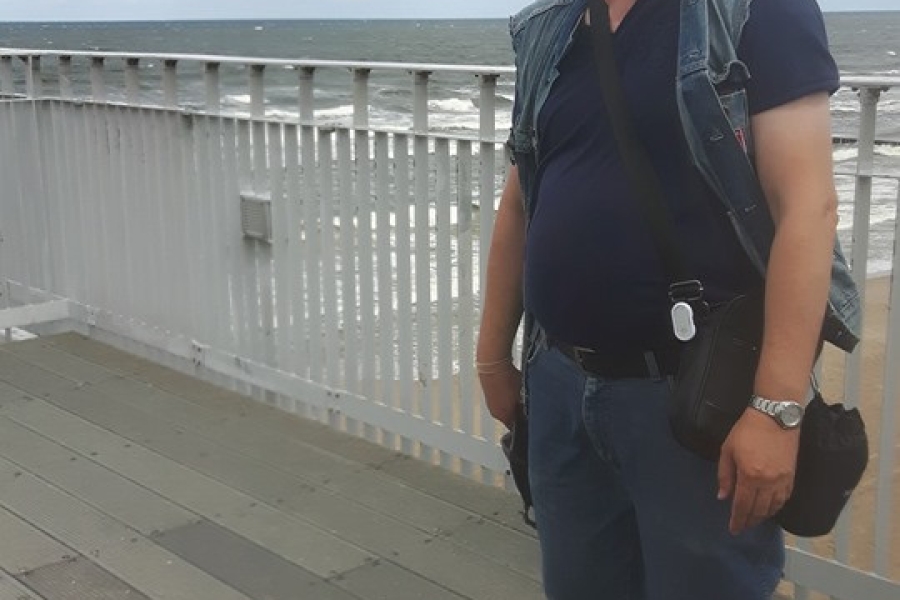 Uczestnik stojący na molo podczas wietrznej pogody.