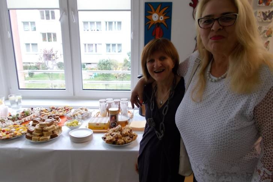 Uczestniczka wraz z terapeutką przy stole z poczęstunkiem